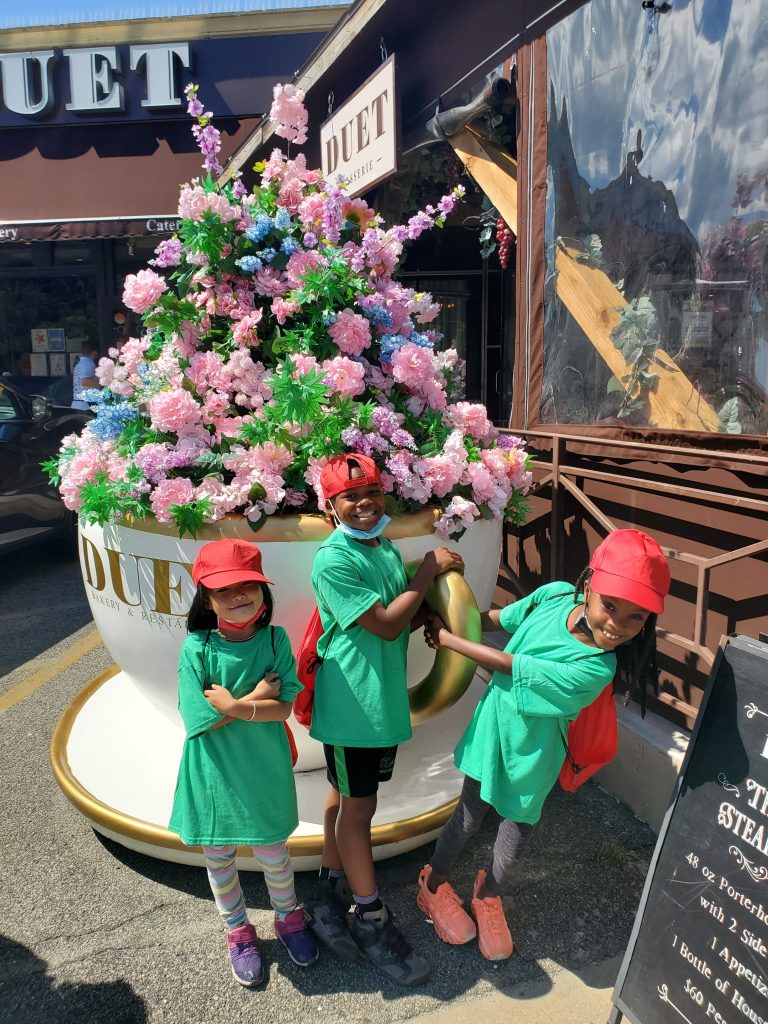 3 children by a large tea cup